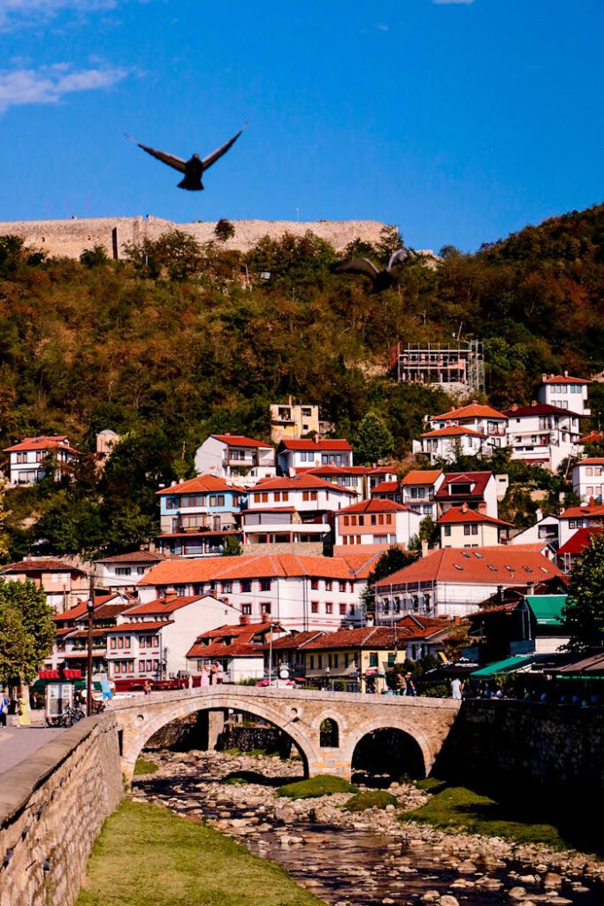pexels-photo-28183670 Capture of Prizren with its charming houses and scenic landscape, featuring a historic stone bridge.